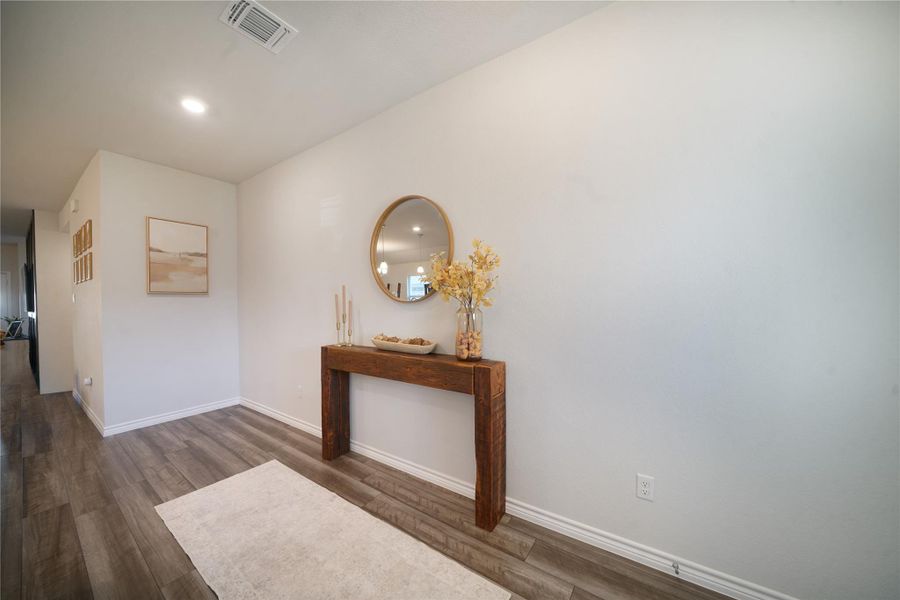 Hall featuring dark wood finished floors and recessed lighting
