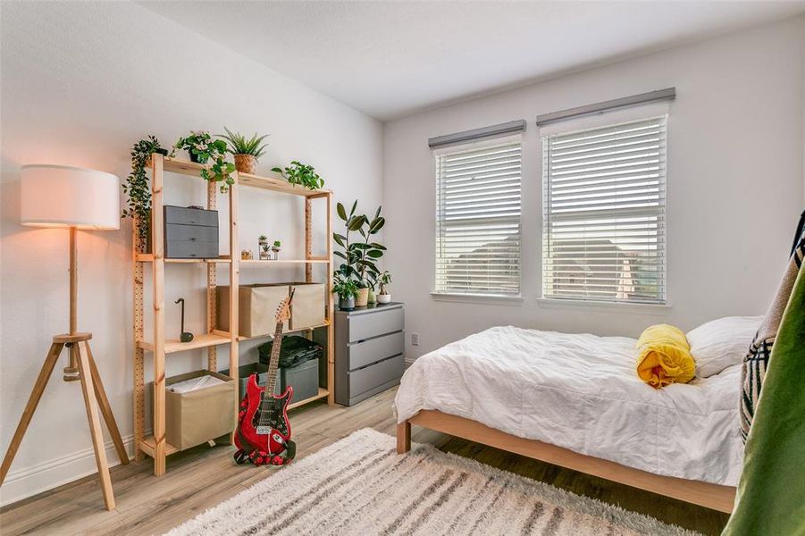 Bedroom featuring light wood finished floors and baseboards