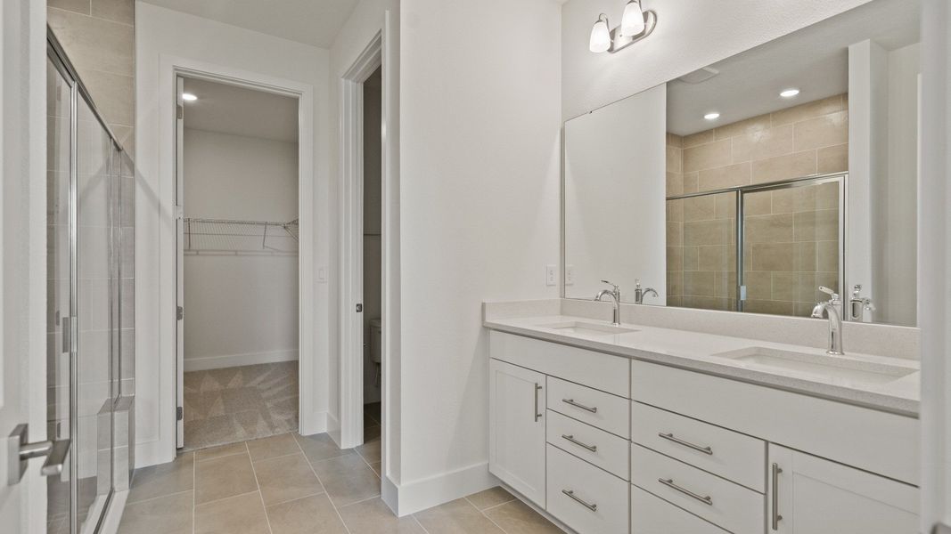 Primary Bathroom in the Buttonwood floorplan showing dual sinks by DRB Homes at Lakeside at Satilla in Saint Cloud, FL