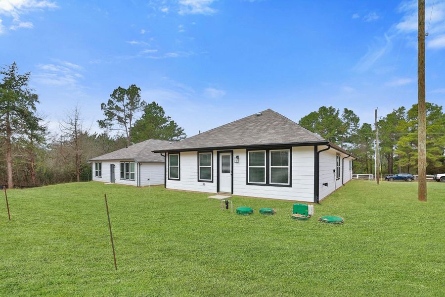 The backyard is sodded and has easy access to the septic equipment. The home features multiple windows, providing plenty of natural light.