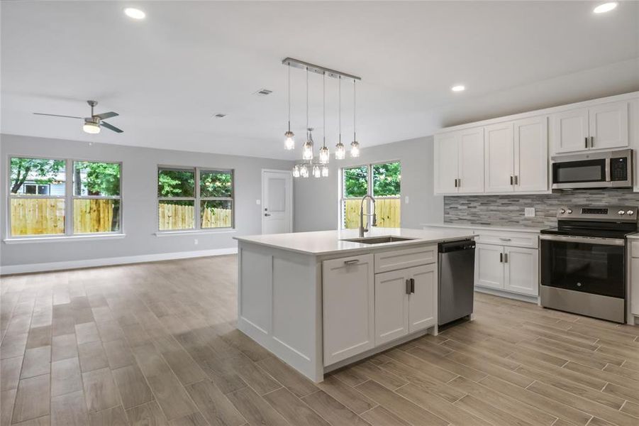 Kitchen with sink, white cabinetry, plenty of natural light, and stainless steel appliances