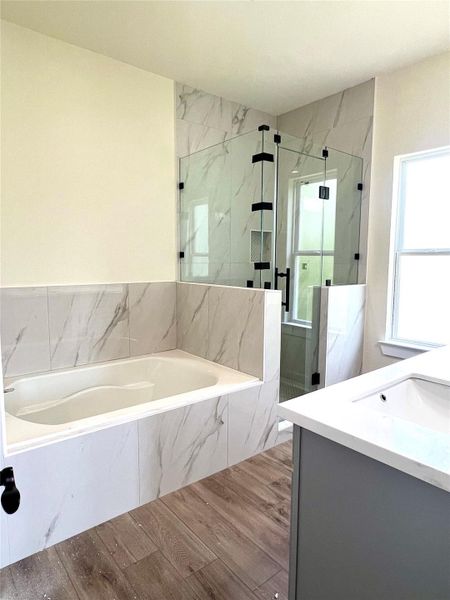 Master bathroom featuring a spacious walk-in shower and a large soaking tub. Master bathroom featuring a spacious walk-in shower and a large soaking tub.