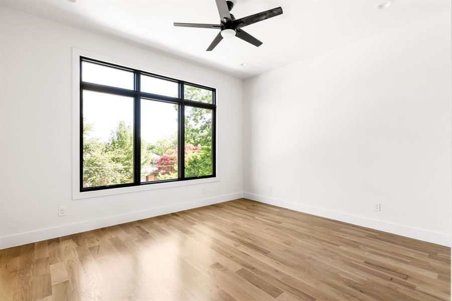 Unfurnished room featuring light wood finished floors and a ceiling fan Unfurnished room featuring light wood finished floors and a ceiling fan