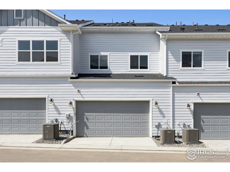 Front exterior of a new home in Kinston Mainstreet Townhomes, Loveland, CO, highlighting curb appeal (Image 24). Front exterior of a new home in Kinston Mainstreet Townhomes, Loveland, CO, highlighting curb appeal (Image 24).