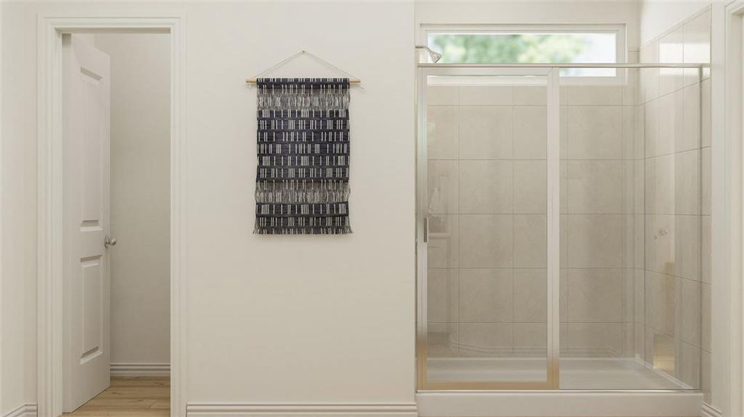 Bathroom featuring wood-type flooring and walk in shower