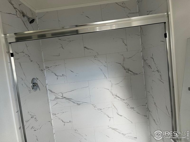 Primary shower with elevated shower head Primary shower with elevated shower head