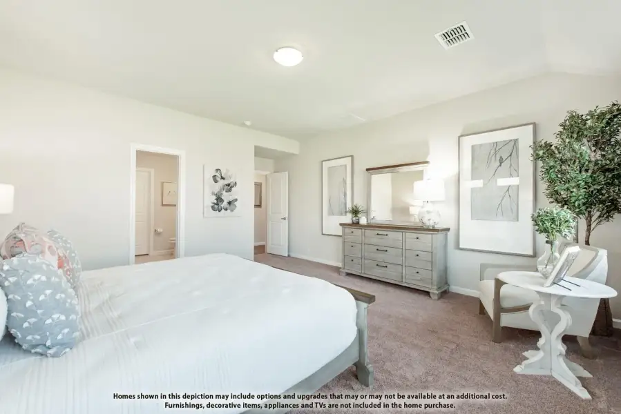 Master bedroom with carpet flooring, dresser with mirror, and doorway leading to ensuite bathroom