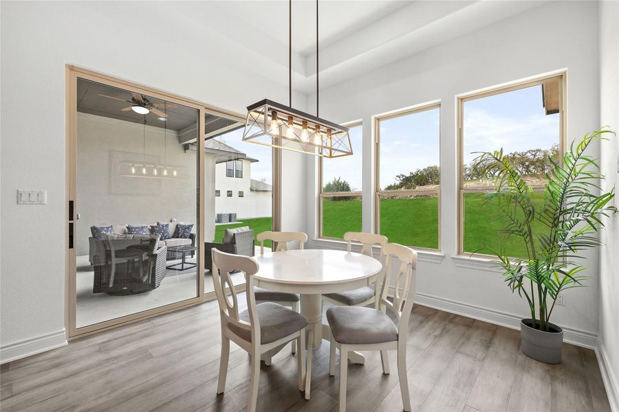 Dining area featuring wood finished floors and a chandelier