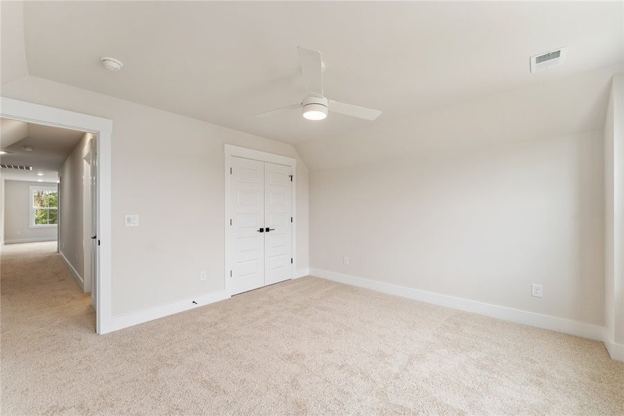 This airy bedroom offers comfortable carpet floori