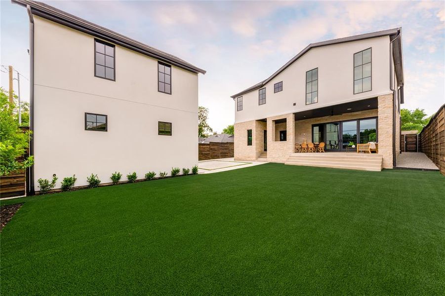Rear view of house featuring a patio area, a fenced backyard, and stucco siding