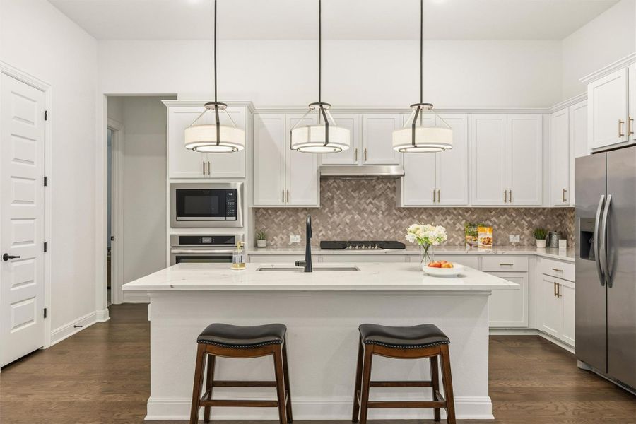 Kitchen with white cabinetry, appliances with stainless steel finishes, tasteful backsplash, and dark wood-type flooring
