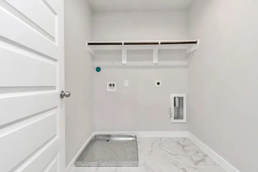 A perfect blend of functionality and comfort. Laundry room, thoughtfully equipped with shelving for effortless organization. Both gas and electric connections available. Sample photo of completed home with similar floor plan. Actual colors and selections may vary. A perfect blend of functionality and comfort. Laundry room, thoughtfully equipped with shelving for effortless organization. Both gas and electric connections available. Sample photo of completed home with similar floor plan. Actual colors and selections may vary.