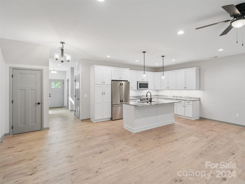 kichen also features counter height island with matching counter tops, farmsink within and microwave/air fryer kichen also features counter height island with matching counter tops, farmsink within and microwave/air fryer