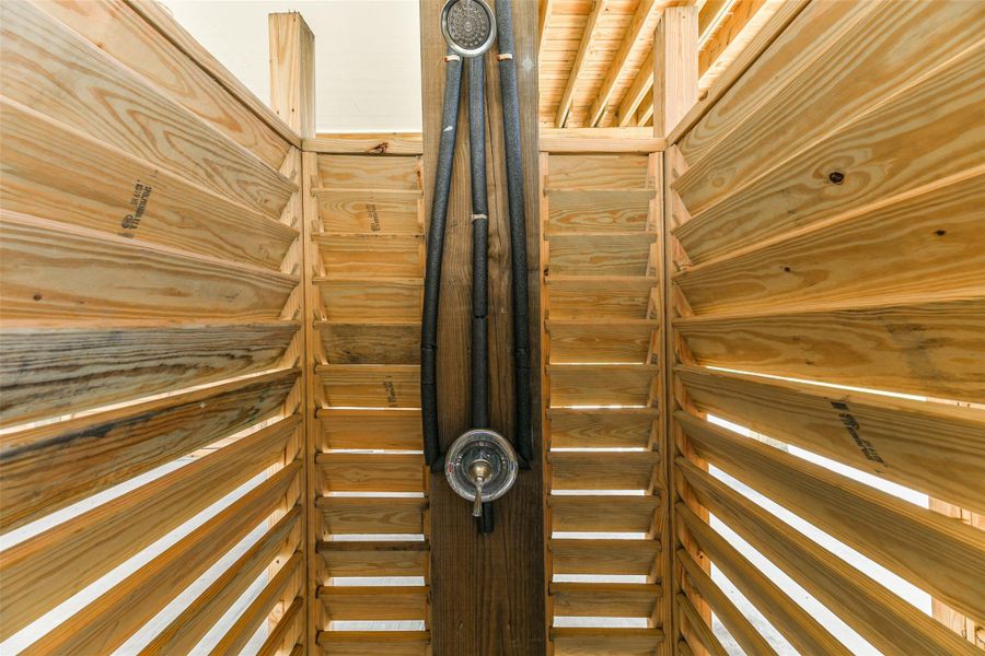 Outdoor shower to rinse off after a day out in the sun or returning from the beach Outdoor shower to rinse off after a day out in the sun or returning from the beach