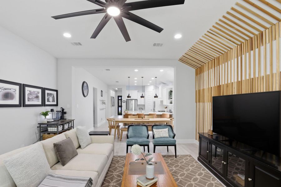 Expansive sightlines and consistent plank flooring highlight the functional, airy layout of the home.