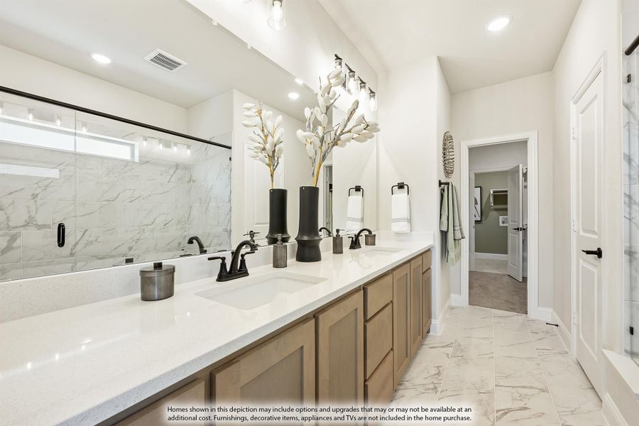Master bathroom with double vanity, quartz countertops, wood cabinets, and marble-tile walk-in shower