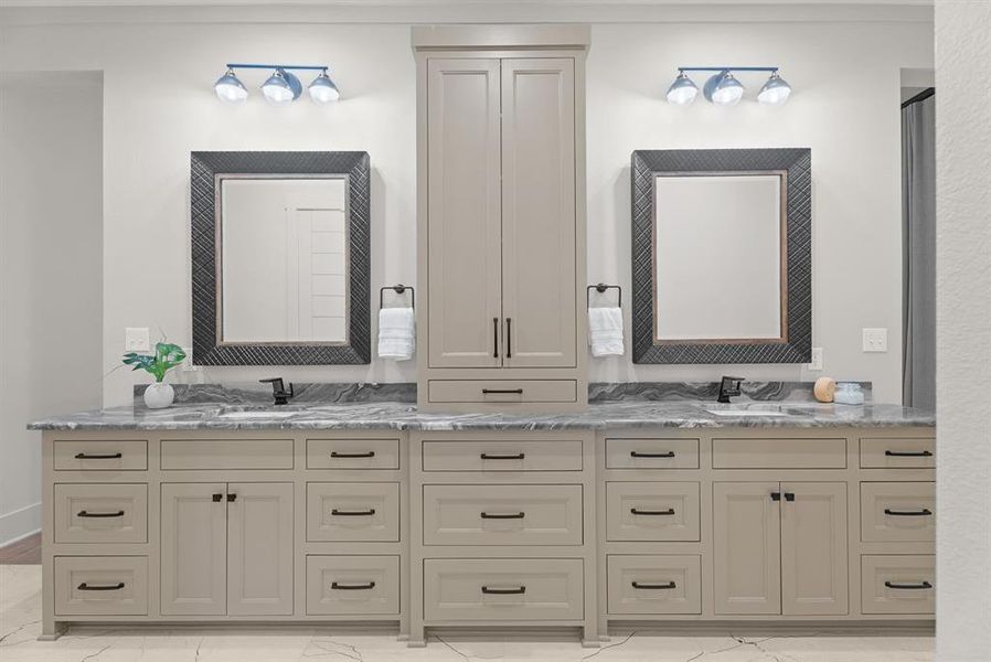 Bathroom featuring double vanity and light marble finish floors