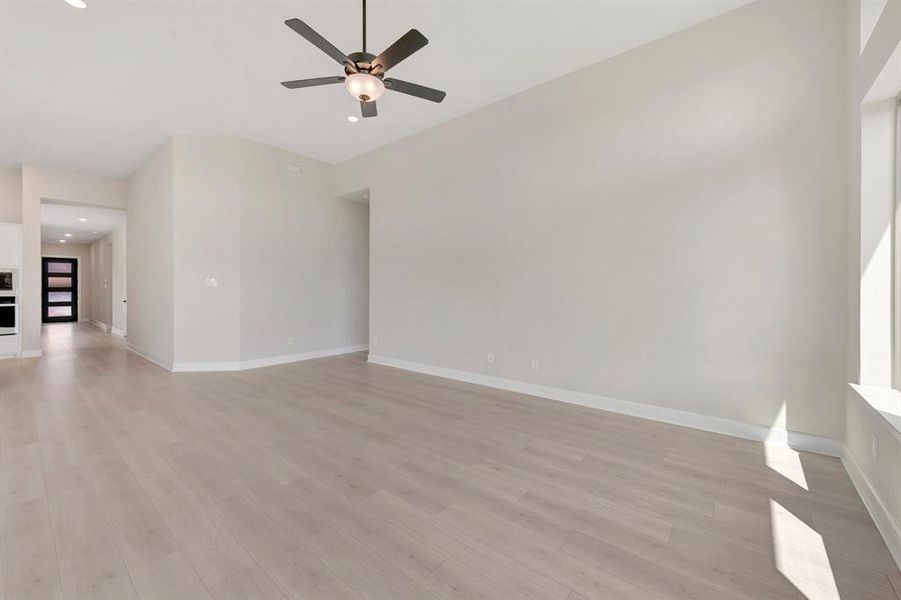 Spacious interior with high ceilings and light wood-finish flooring