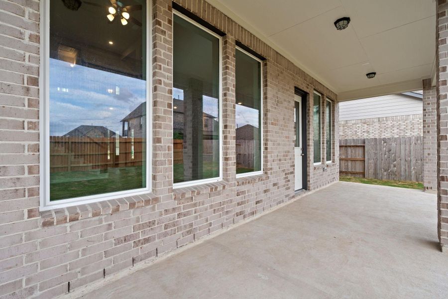The covered patio is generously sized, providing ample space for various outdoor activities.