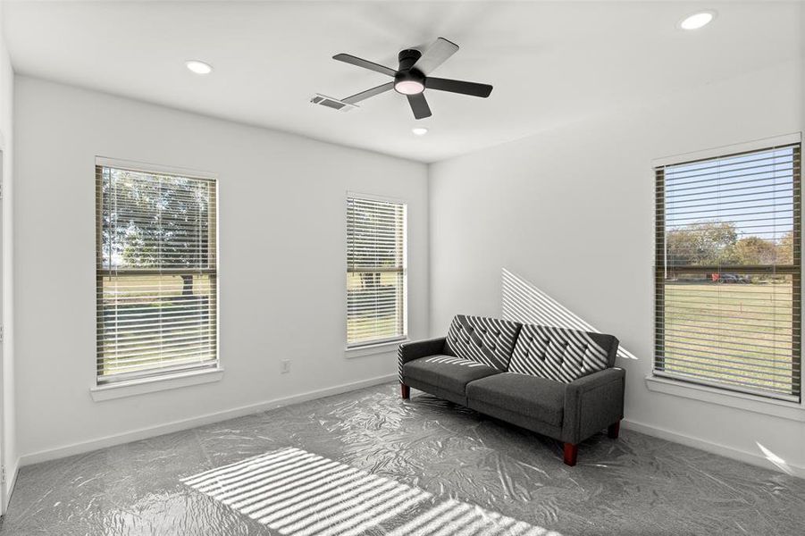 Sitting room with plenty of natural light, recessed lighting, and a ceiling fan