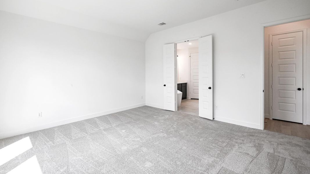 Unfurnished bedroom featuring ensuite bathroom and carpet Unfurnished bedroom featuring ensuite bathroom and carpet