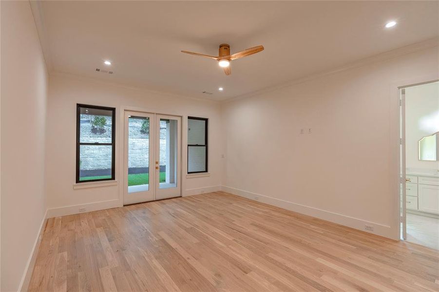 Primary with doors leading to backyard
