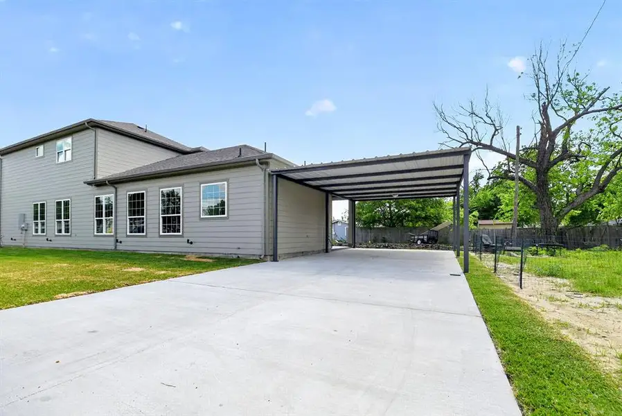 View of property exterior with concrete driveway and a carport View of property exterior with concrete driveway and a carport