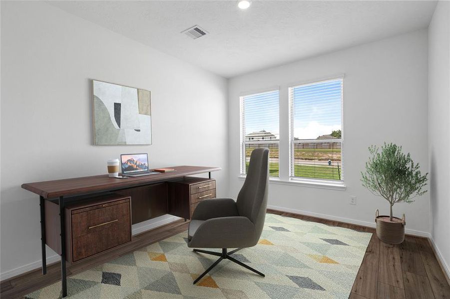 Quietly nestled in front of the home is the handsome den that can be used as an office, play room, dining room, or whatever your hearts desire. Featuring vinyl plank flooring, high ceilings, large windows with privacy blinds and neutral paint.