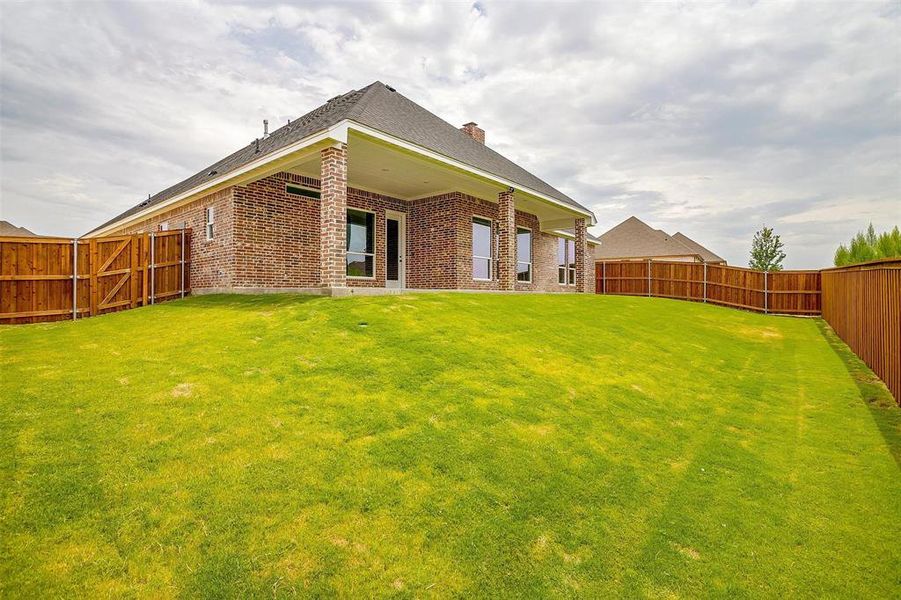 Rear view of property featuring a lawn