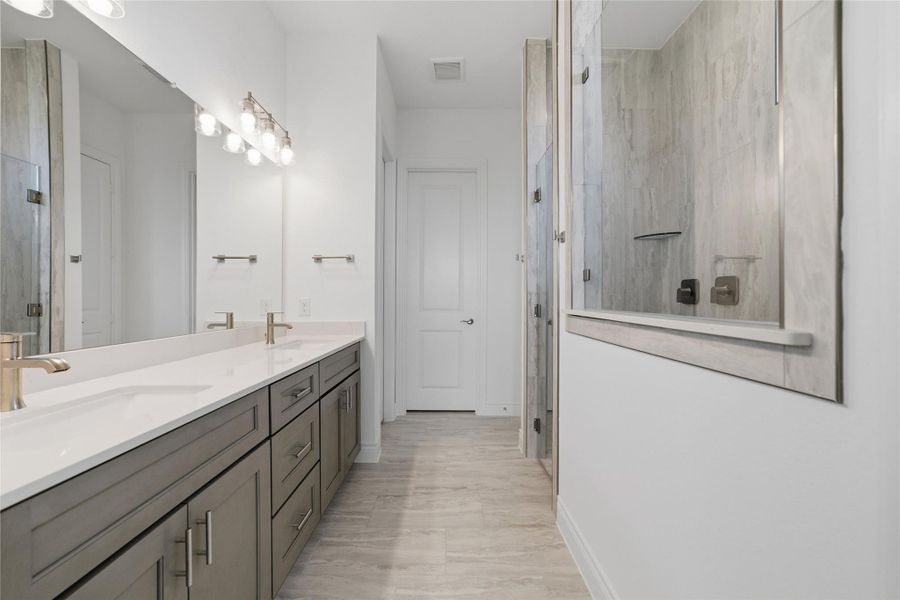 A spacious mega shower paired with double vanity sinks creates a luxurious, spa-like primary bathroom.