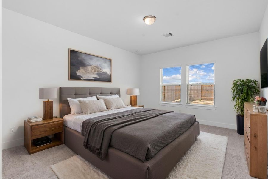 Virtually staged to showcase the spacious layout, this serene primary suite is privately tucked away on the main floor, offering the perfect retreat from the rest of the home. Large windows bring in beautiful natural light to start and end your day in comfort. Virtually staged to showcase the spacious layout, this serene primary suite is privately tucked away on the main floor, offering the perfect retreat from the rest of the home. Large windows bring in beautiful natural light to start and end your day in comfort.