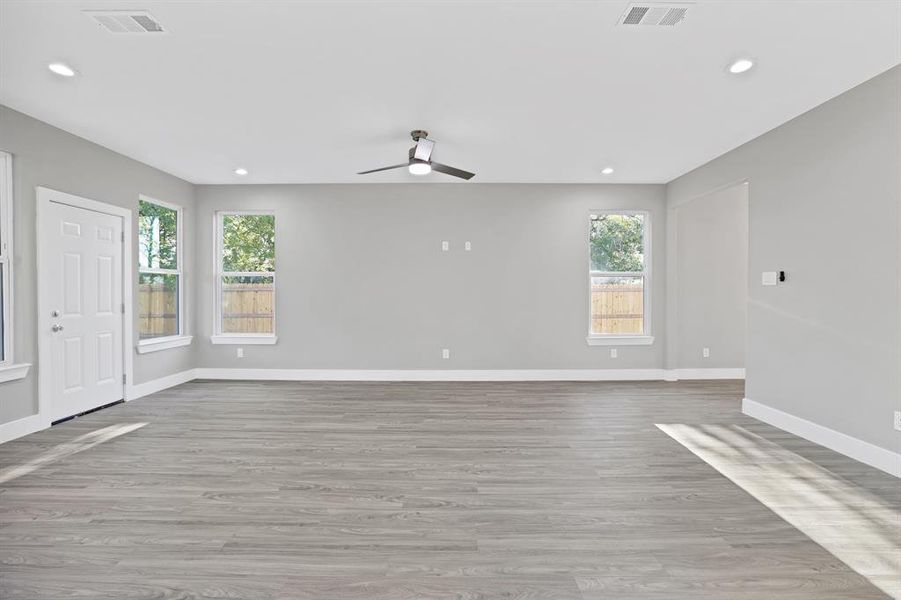 Unfurnished room featuring ceiling fan and light hardwood / wood-style flooring