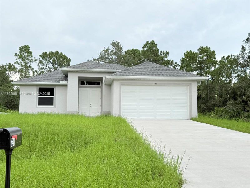 Front exterior of a new home in , Lehigh Acres, FL, highlighting curb appeal (Image 2). Front exterior of a new home in , Lehigh Acres, FL, highlighting curb appeal (Image 2).