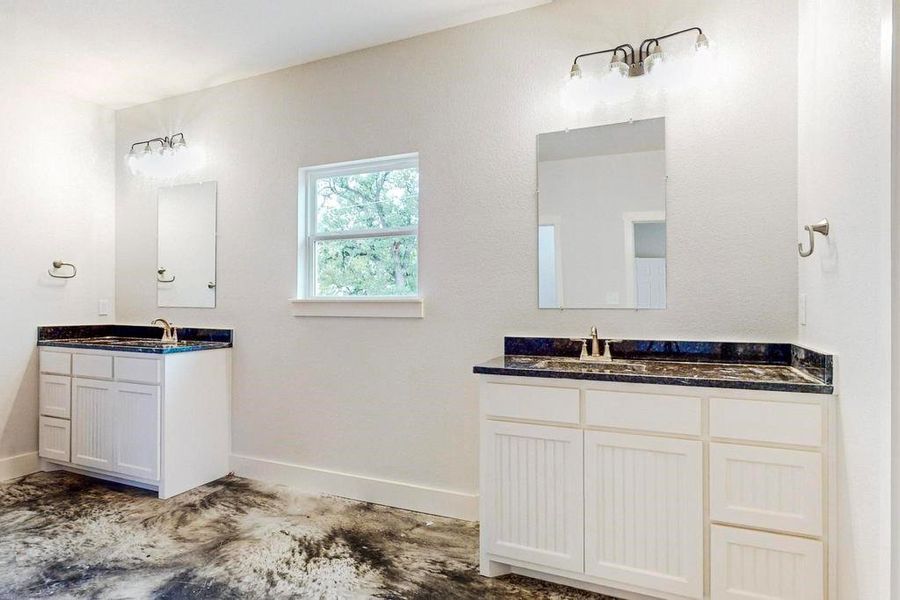 Bathroom with vanity and concrete flooring