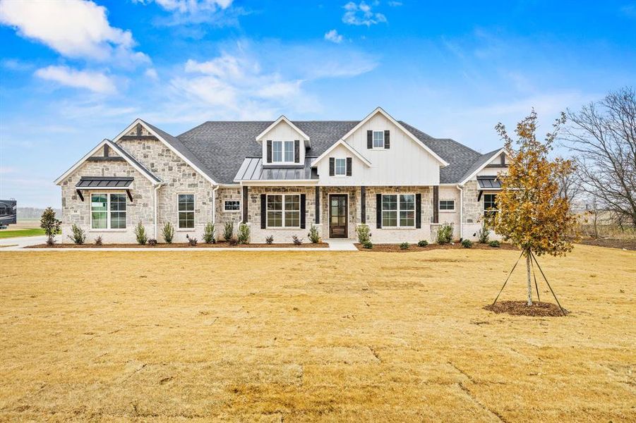 View of front of house featuring a standing seam roof, a porch, and roof with shingles View of front of house featuring a standing seam roof, a porch, and roof with shingles