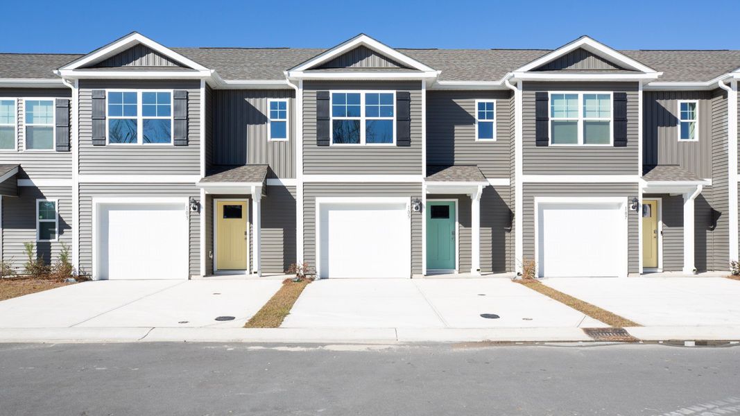 Front exterior of a new home in Waterside Townhomes, Surf City, NC, highlighting curb appeal (Image 1).