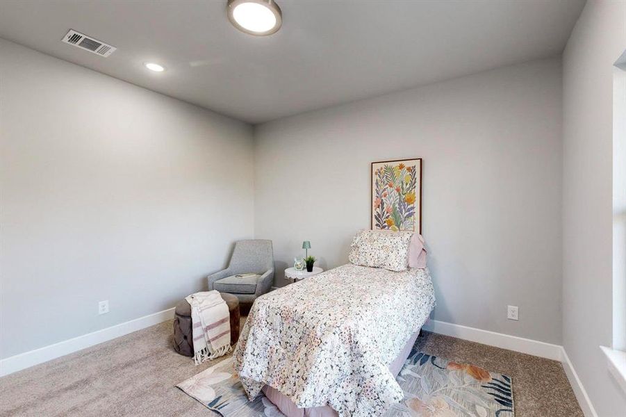 Bedroom featuring light colored carpet