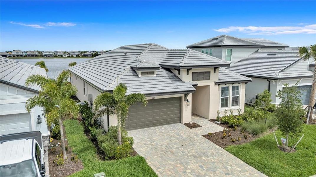 Front exterior of a new home in Sweetwater at Lakewood Ranch, Bradenton, FL, highlighting curb appeal (Image 2). Front exterior of a new home in Sweetwater at Lakewood Ranch, Bradenton, FL, highlighting curb appeal (Image 2).