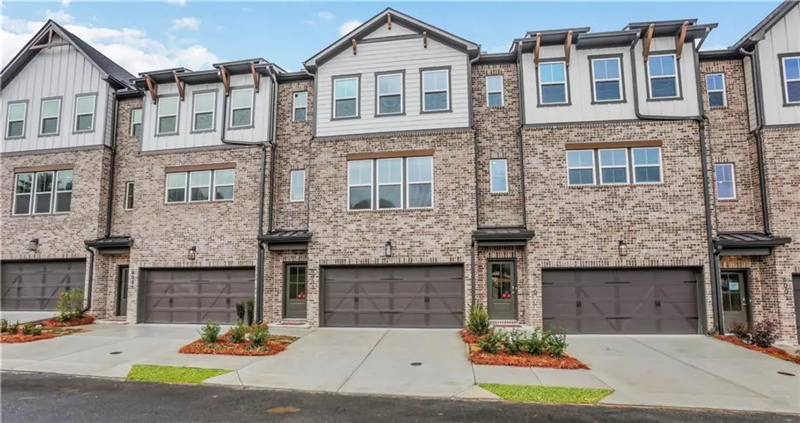 Front exterior of a new home in Towne Village at Suwanee Dam, Sugar Hill, GA, highlighting curb appeal (Image 1). Front exterior of a new home in Towne Village at Suwanee Dam, Sugar Hill, GA, highlighting curb appeal (Image 1).