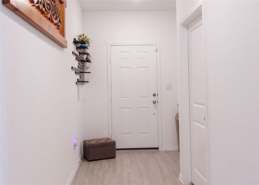 Stunning grand entry with wood-style floors, creating a warm and inviting first impression.