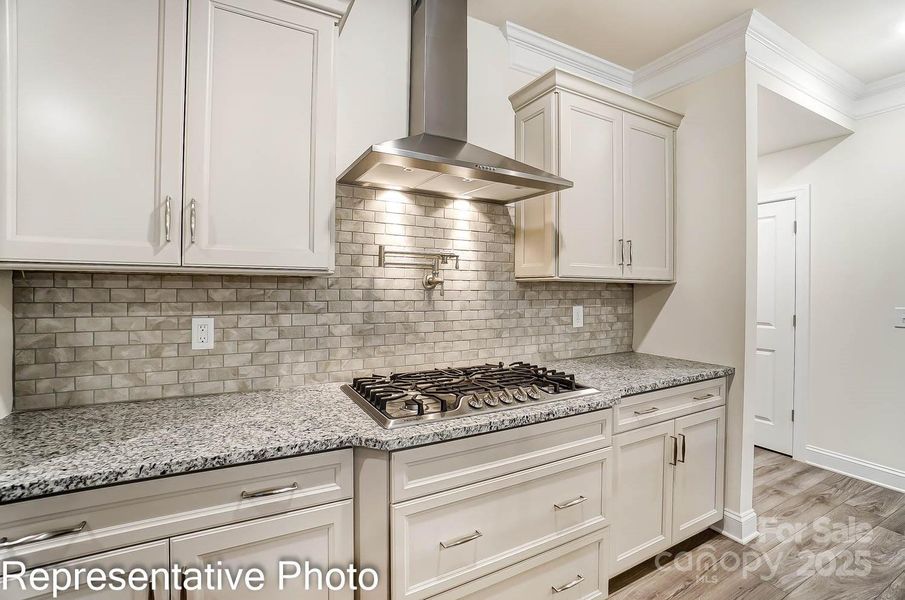 Stainless Steel appliances included - featuring designer range hood and gas cooktop