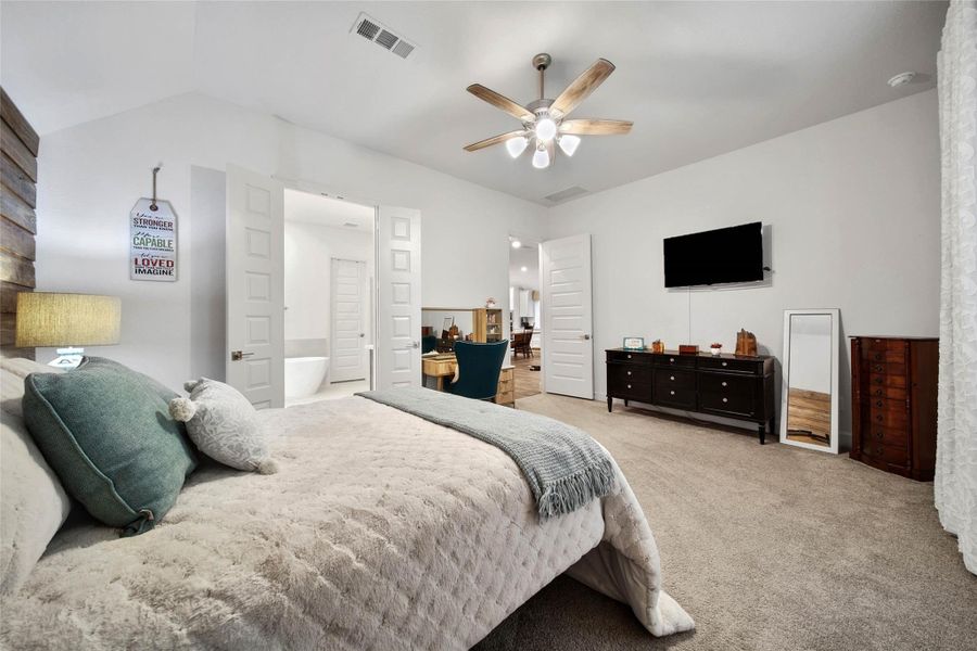 A true private retreat, the spacious primary suite opens to a luxurious bath.