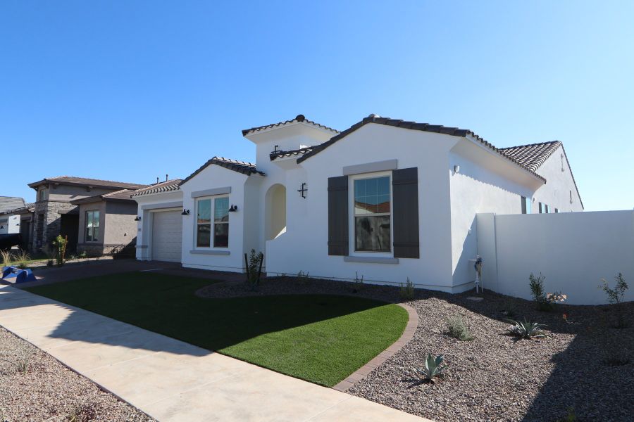 Front exterior of a new home in Escena at Blossom Rock, Apache Junction, AZ, highlighting curb appeal (Image 2). Front exterior of a new home in Escena at Blossom Rock, Apache Junction, AZ, highlighting curb appeal (Image 2).