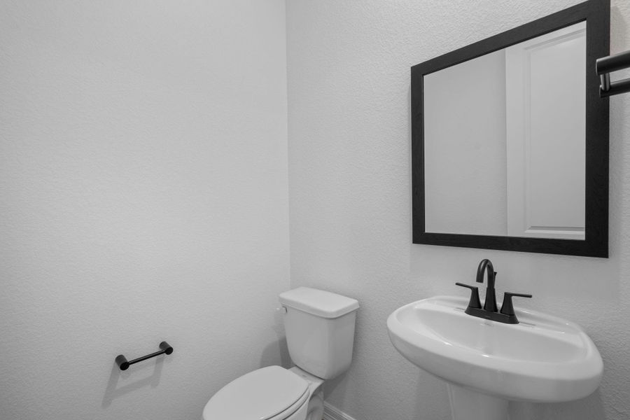 This charming home features a beautifully appointed half bath adjacent to the family room, perfect for welcoming guests and adding convenience to your daily life.