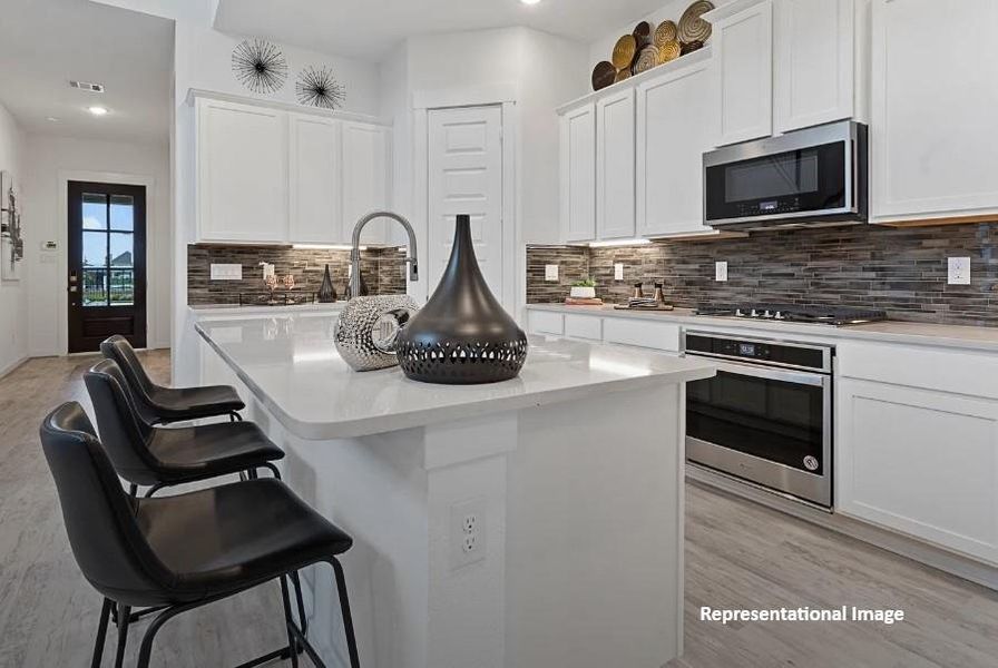 The sleek countertops, with their soft veining, invite you to gather around, whether for a quick breakfast or a weekend feast with friends.