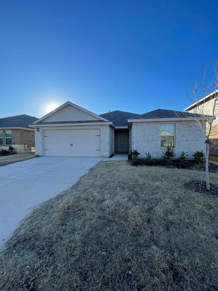 Ranch-style home featuring a garage and a front yard