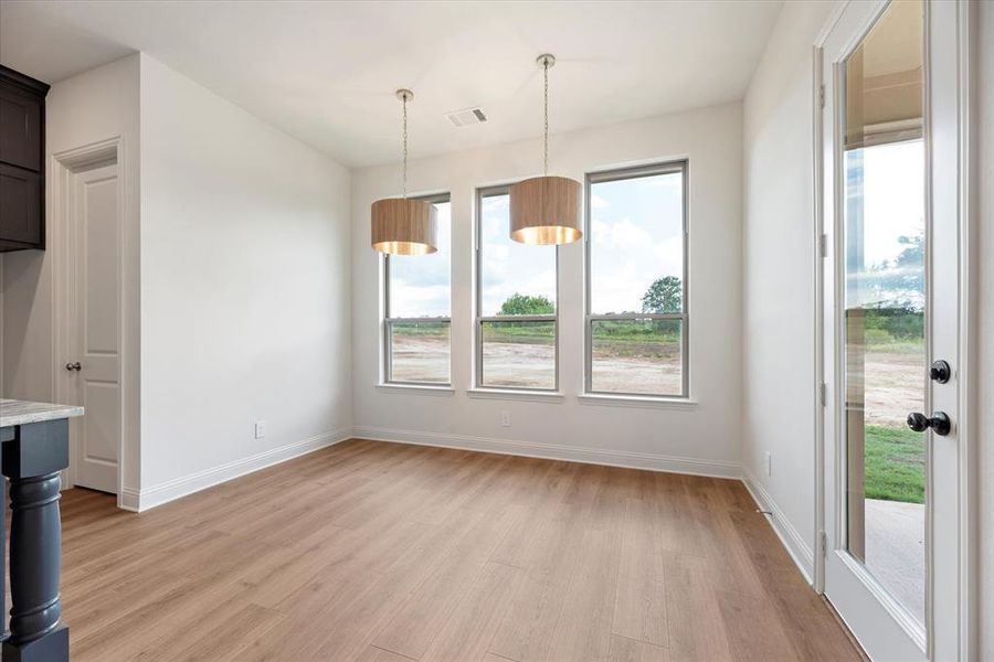 Unfurnished dining area featuring light hardwood / wood-style floors