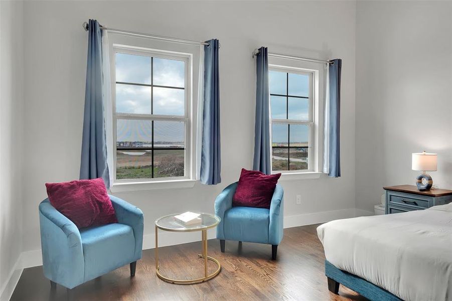 Bedroom featuring wood finished floors and baseboards