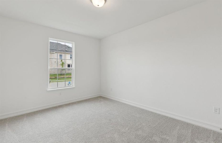 Convenient first-floor secondary bedroom for easy access  *Real home pictured