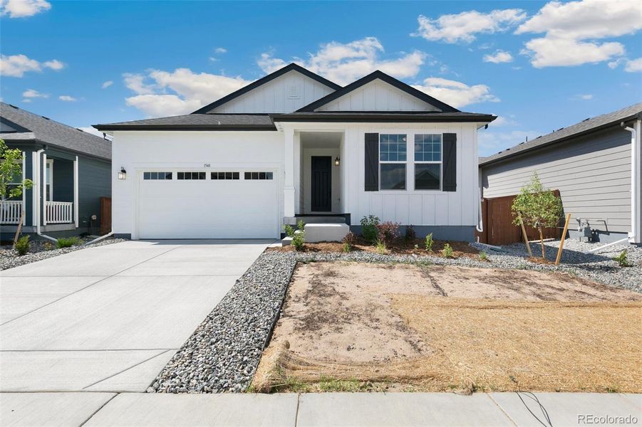 Front exterior of a new home in Farmlore, Brighton, CO, highlighting curb appeal (Image 2).
